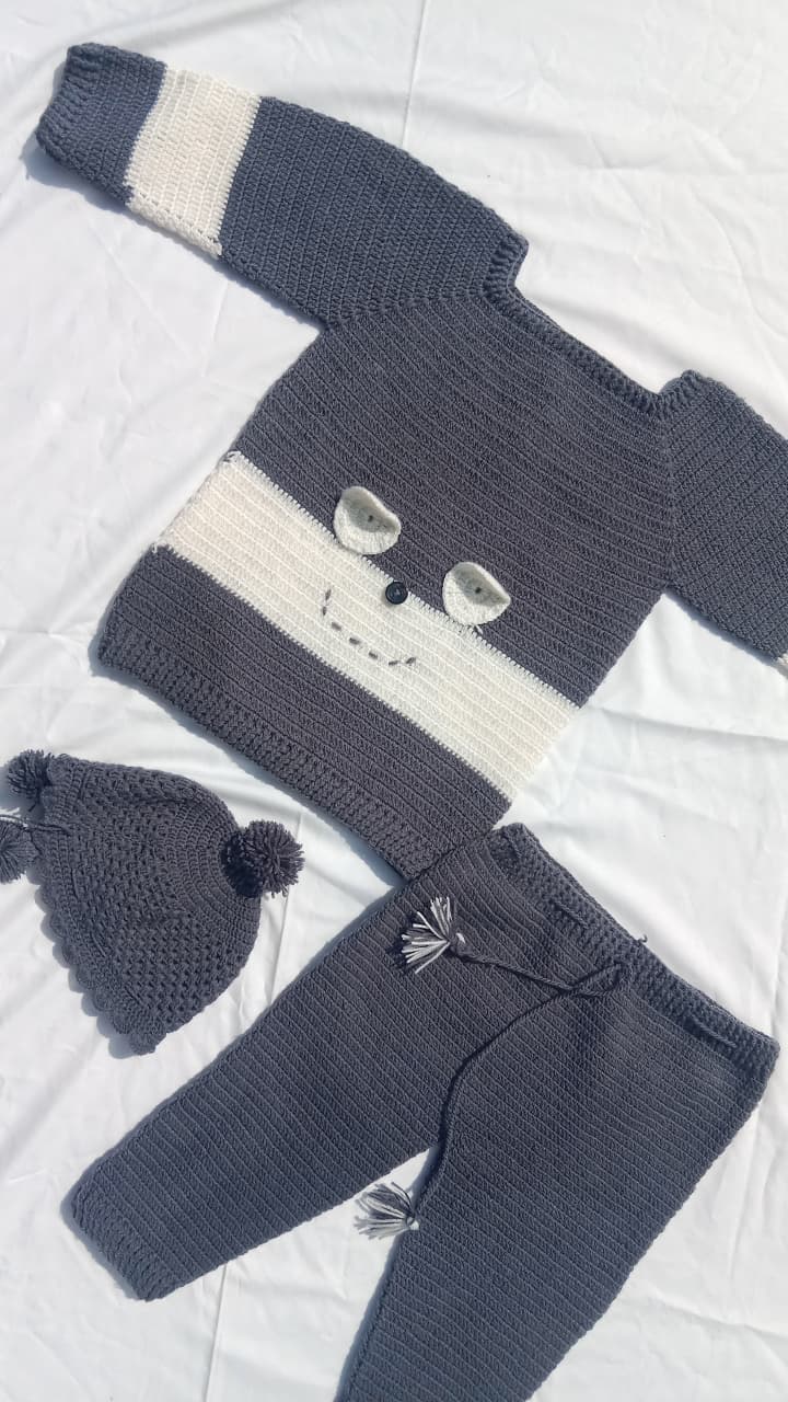 Warm crochet blanket folded on a chair